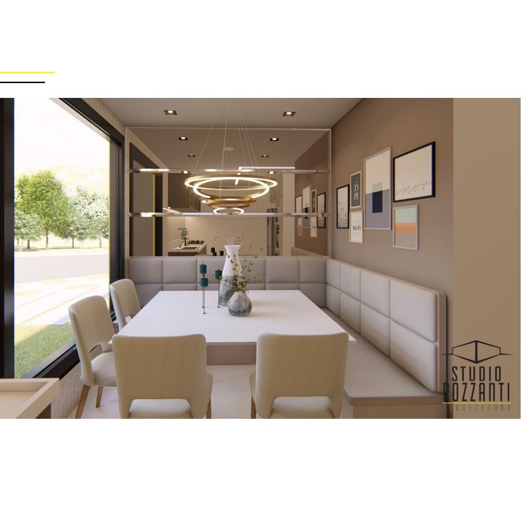 Sala de jantar contemporânea com lustre de anéis, banco estofado e galeria de quadros